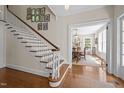 Open foyer showcases hardwood floors, staircase, and an adjacent dining room filled with natural light at 1217 Aycock Ave, Burlington, NC 27215
