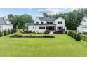Expansive backyard featuring lush greenery, manicured landscaping, and a private fenced perimeter at 1229 Perry Bluff Dr, Wake Forest, NC 27587