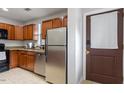 Efficient kitchen featuring stainless steel appliances, and wood cabinets at 130 E Longview St # Apt S, Chapel Hill, NC 27516