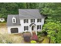 Charming two-story home with a brick facade, black shutters, and well-manicured landscaping at 1312 Stonemoor Ct, Raleigh, NC 27606