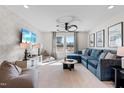 Cozy bonus room featuring a comfortable blue sectional, a ceiling fan, and a large window at 147 Sugar Pine Drive, Franklinton, NC 27525