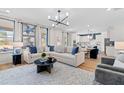 Open-concept living room showcasing stylish decor, comfortable seating, and natural light, connecting to the modern kitchen at 147 Sugar Pine Drive, Franklinton, NC 27525