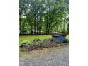 Landscaped yard with mature hostas and outbuilding at 1634 Hurdle Mills Rd, Roxboro, NC 27574