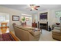 Cozy living room featuring a fireplace with built-in TV and an adjacent dining area at 1703 Berwickshire Cir, Raleigh, NC 27615
