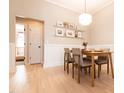Dining room with modern table and chairs, decorative shelves, and stylish pendant lighting at 1816 Piperwood Ct, Durham, NC 27713