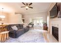 Comfortable living room featuring a fireplace, hardwood floors, and a stylish rug at 1816 Piperwood Ct, Durham, NC 27713