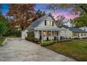 Lovely home featuring a long driveway, covered porch, and mature landscaping, exuding curb appeal at 1917 Washington St, Durham, NC 27704