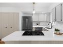 Modern kitchen boasts stainless steel appliances, a gas cooktop, and pristine white cabinetry at 1917 Washington St, Durham, NC 27704