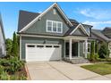 Charming two-story home with a beautiful lawn, inviting front porch, and a convenient attached two-car garage at 192 Logbridge Rd, Chapel Hill, NC 27516