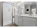 Modern bathroom featuring a double vanity, a glass enclosed shower, and white countertops, all illuminated with natural light at 200 Sugar Pine Drive, Franklinton, NC 27525