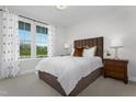Cozy bedroom featuring a plush bed, ample natural light from a large window, and elegant decor at 200 Sugar Pine Drive, Franklinton, NC 27525