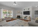 Bright and inviting living room features a cozy fireplace and plenty of natural light at 2012 Sterling Hill Dr, Fuquay Varina, NC 27526