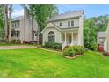 Charming two-story home features a well-manicured lawn, inviting front porch, and classic architectural details at 203 Lighthouse Way, Cary, NC 27511
