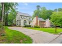 Lovely home with long driveway, manicured lawn, mature trees, and traditional architecture creating an inviting curb appeal at 203 Lighthouse Way, Cary, NC 27511