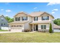 Charming two-story home featuring a two-car garage, well-manicured lawn, and classic curb appeal at 222 Trailing Oak Trl, Clayton, NC 27527