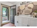 Inviting entryway featuring a custom welcome sign, and storage bench, illuminated by natural light at 2410 Overbrook Ln, Sanford, NC 27330