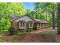Well-maintained brick home with mature trees, landscaping, and a bay window on a quiet lot at 2410 Overbrook Ln, Sanford, NC 27330
