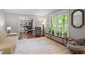 Bright living room with hardwood floors and a large window providing natural light at 2410 Overbrook Ln, Sanford, NC 27330