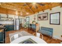An open-concept kitchen and dining area with stainless steel appliances and hardwood floors at 2508 Albany St, Durham, NC 27705