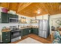 A full view of the kitchen with stainless steel appliances, wooden countertops, and white subway tile backsplash at 2508 Albany St, Durham, NC 27705