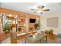 A view of the living room with a decorative brick shelf, an earth-toned accent wall, and hardwood floors at 2508 Albany St, Durham, NC 27705