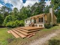 Expansive wooden deck with multiple tiers, ideal for enjoying the peaceful and private backyard at 280 Sagamore Dr, Louisburg, NC 27549