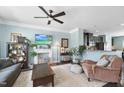 Inviting living room with fireplace, ceiling fan, and open view to modern kitchen at 309 Old Mill Village Dr, Apex, NC 27502