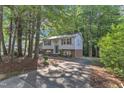 Split-level home showcasing the facade and wooded surroundings at 309 Penn Oak Cir, Raleigh, NC 27615