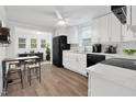 Bright kitchen with white cabinets, stainless appliances, and adjacent breakfast area at 313 W Church St, Angier, NC 27501