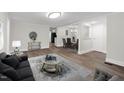 Inviting living room flows into dining area with hardwood floors and neutral colors at 313 W Church St, Angier, NC 27501