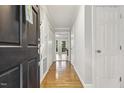 Inviting hallway with gleaming hardwood floors leading to a bright and airy living space at 3420 Greenville Loop Rd, Wake Forest, NC 27587