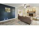 Comfortable living room with a brick fireplace, modern flooring, and stylish décor at 3420 Greenville Loop Rd, Wake Forest, NC 27587