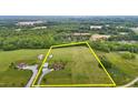 Sprawling acreage showcases a stunning residence with multiple garages in a lush, green setting surrounded by trees at 3465 Covington Trl, Mebane, NC 27302