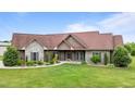 Charming single-story home with stone and wood facade and a lush green lawn at 3465 Covington Trl, Mebane, NC 27302