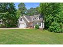 Charming home with manicured lawn, two-car garage, and inviting brick-lined front porch at 347 Manchester Trl, Clayton, NC 27527