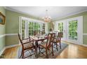 Elegant dining room featuring hardwood floors, a bay window and a chandelier at 4 Barkridge Ct, Durham, NC 27713