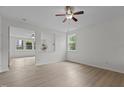 Open-concept living space with light wood floors and plenty of natural light at 4003 Jockey Club Cir, Cary, NC 27519