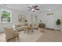 Inviting living room featuring neutral tones, a cozy seating arrangement and lots of natural light at 4003 Jockey Club Cir, Cary, NC 27519