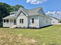 Side view of home showcasing the exterior with professional landscaping and a manicured lawn at 4016 Berman Edge Rd, Holly Springs, NC 27540