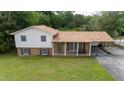 Aerial view of a well-maintained two-story home with a spacious yard and convenient carport at 409 Ivey Rd, Graham, NC 27253