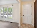 Inviting foyer with large windows, a patterned tile floor, and a view of the living area at 409 Ivey Rd, Graham, NC 27253