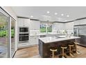 Bright kitchen with island seating, modern appliances, and ample cabinet space at 4213 Oak Park Rd, Raleigh, NC 27612