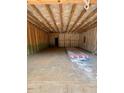 Spacious, unfinished two-car garage with exposed beams and open layout at 452 Golden Dragonfly St, Wake Forest, NC 27587