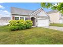 Charming single-story home featuring manicured landscaping and a two-car garage at 57 S Great White Way, Clayton, NC 27527