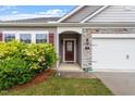 Charming single-story home featuring manicured landscaping and a two-car garage at 57 S Great White Way, Clayton, NC 27527
