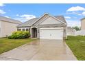 Charming single-story home featuring manicured landscaping and a two-car garage at 57 S Great White Way, Clayton, NC 27527