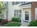 Close-up view of the front yard, showcasing the entryway, landscaping, and well-maintained facade at 5742 Corbon Crest Ln, Raleigh, NC 27612