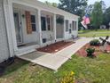Close-up of the front porch with white columns, brick accents and decorative elements at 623 Glenwood Dr, Sanford, NC 27330