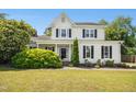 Charming two-story home with manicured lawn and lush landscaping at 6521 Cablewood Dr, Raleigh, NC 27603