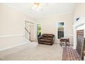 Bright living room with fireplace, neutral carpet, and lots of natural light at 6521 Cablewood Dr, Raleigh, NC 27603